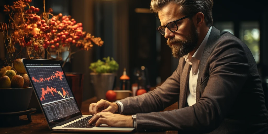 a person sitting at a desk working on a laptop